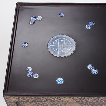 A Chinese black lacquered table with porcelain placques, presumably first half of the 20th century.