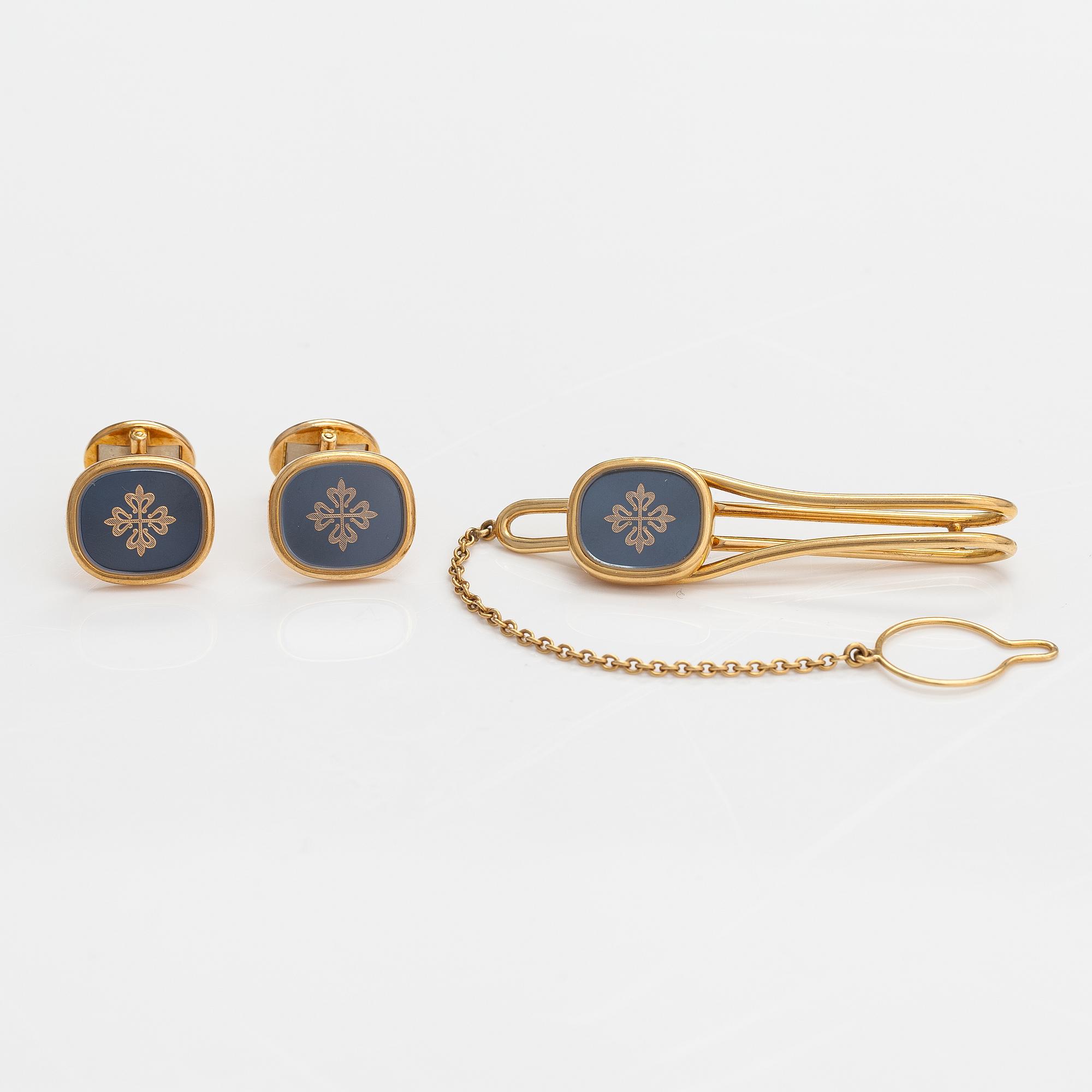 Patek Philippe, Manschettknappar och slipsnål "Ellipse Calatrava", 18K guld och safiglas. Märkta Patek Philippe Geneve.
