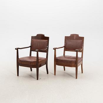 A pair of early 1900s armchairs.