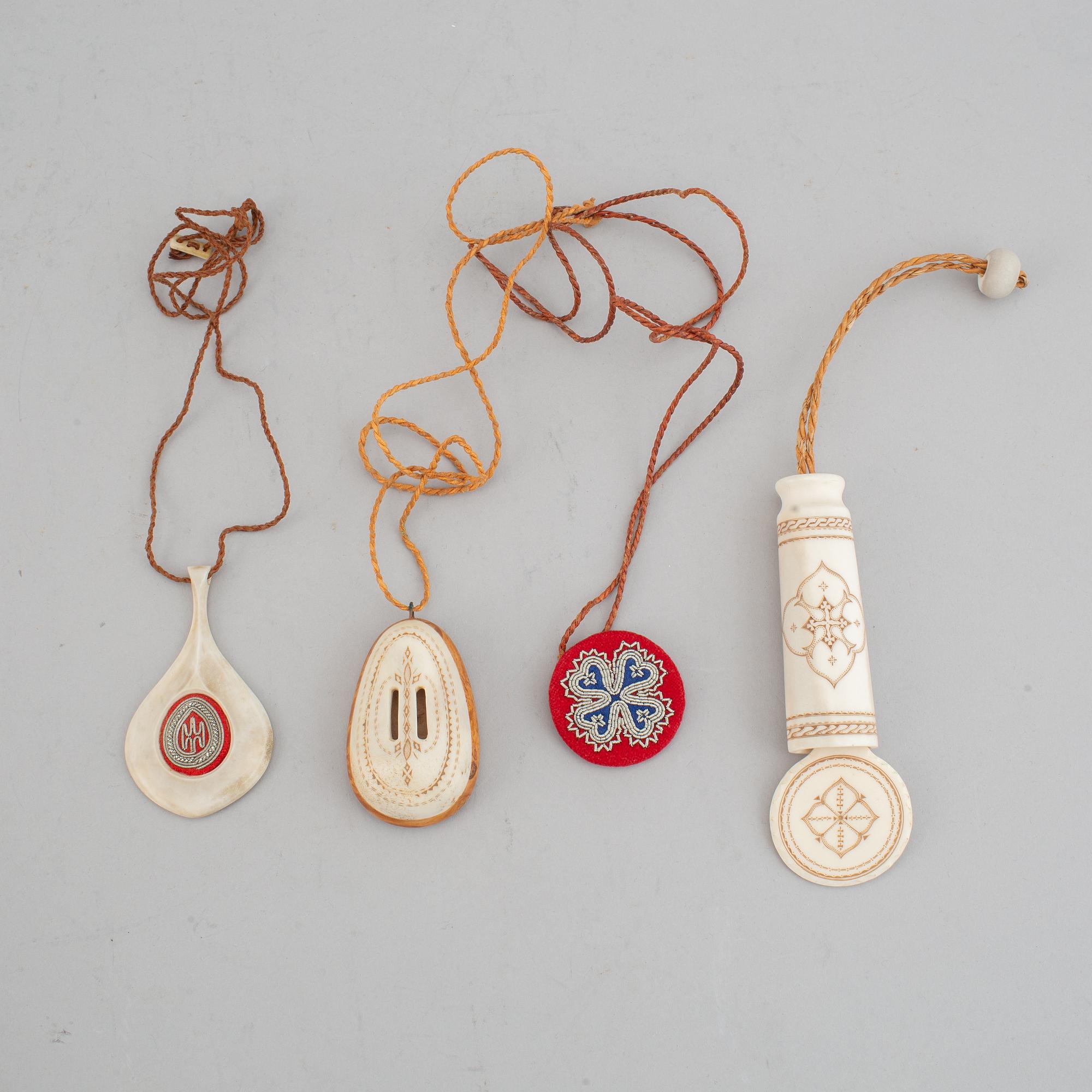 Four Sami pendants, reindeer horn, birch and embroidery with silver thread, one signed TF for Torsten Fankki.