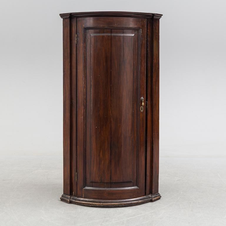 A 19th century corner cabinet.