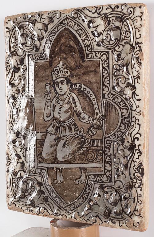 A Qajar moulded figural pottery tile, ca 45 x 35 cm.