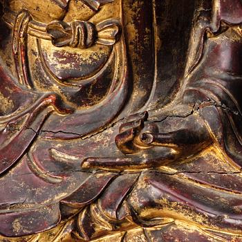 A large gilt and lacquered figure of a seated buddha, Qing dynasty, 19th Century.