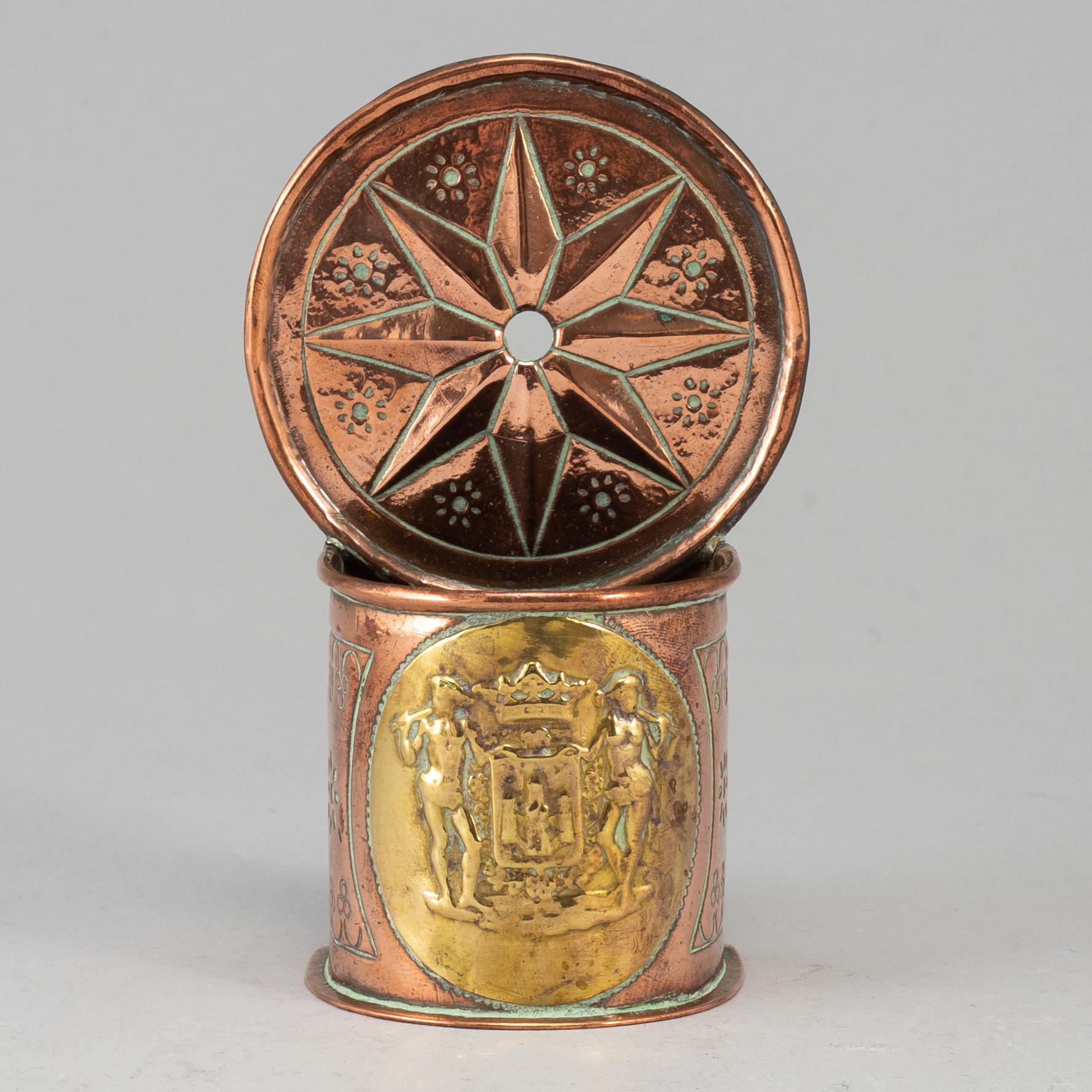 A 19th century brass and copper spoon holder.