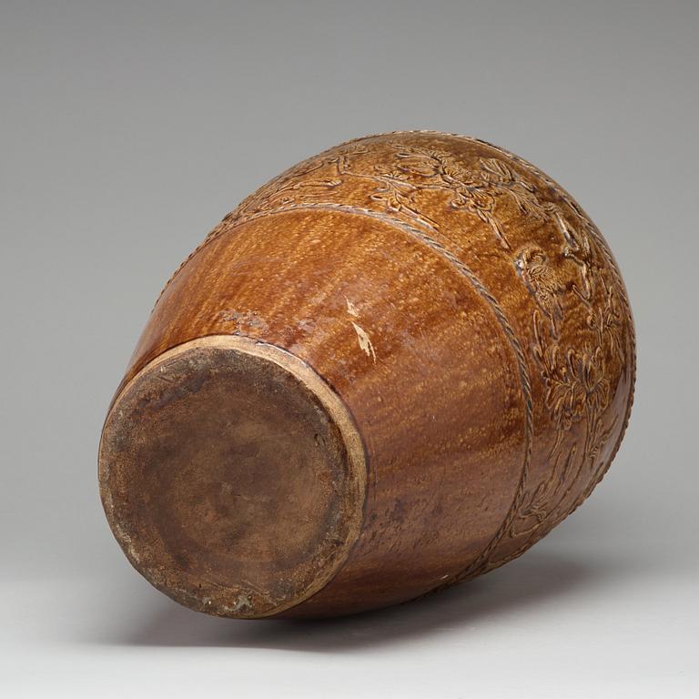 A large brown glazed Martaban jar, presumably 18th Century.