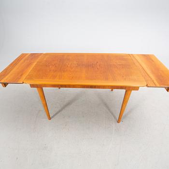 A 1940s mahogany and walnut dining table.