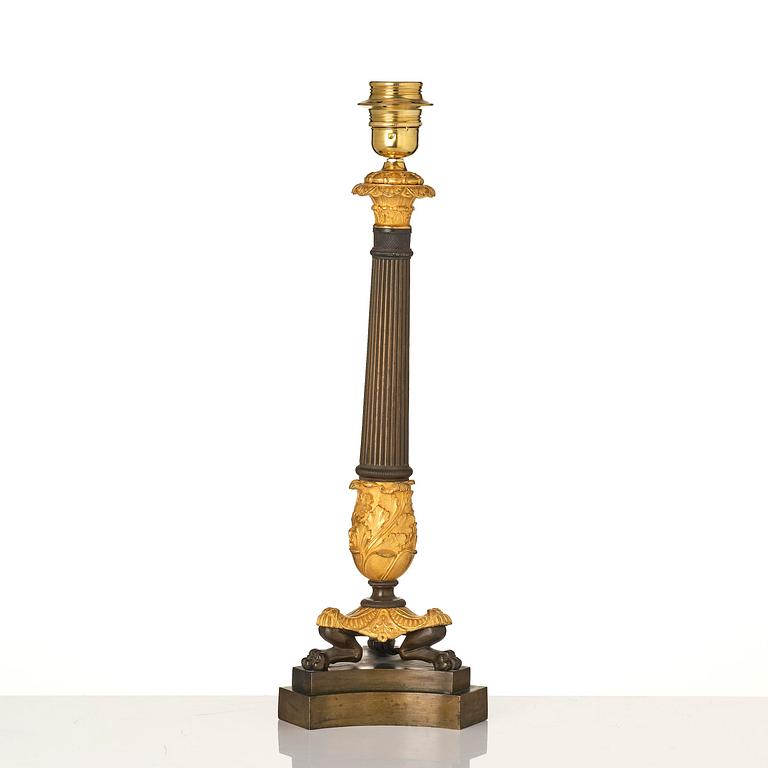 A French Empire ormolu and patinated bronze table lamp, early 19th century.