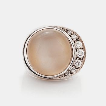 376. An 18K white gold ring set with a cabochon-cut moonstone and round brilliant-cut diamonds.