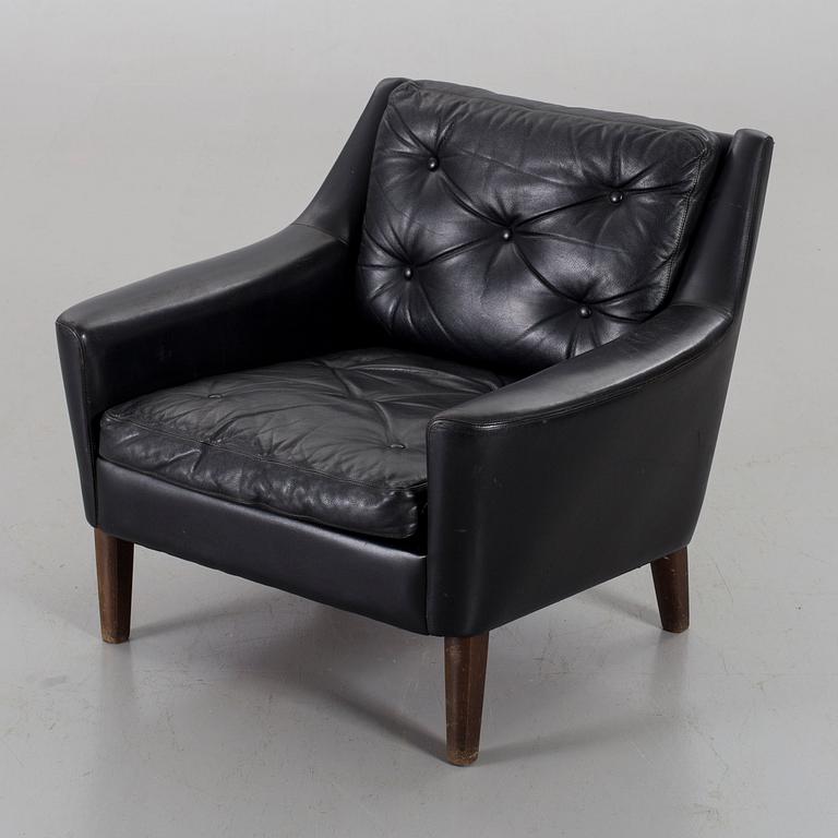 A 1960s Scandinavian black leather easy chair.