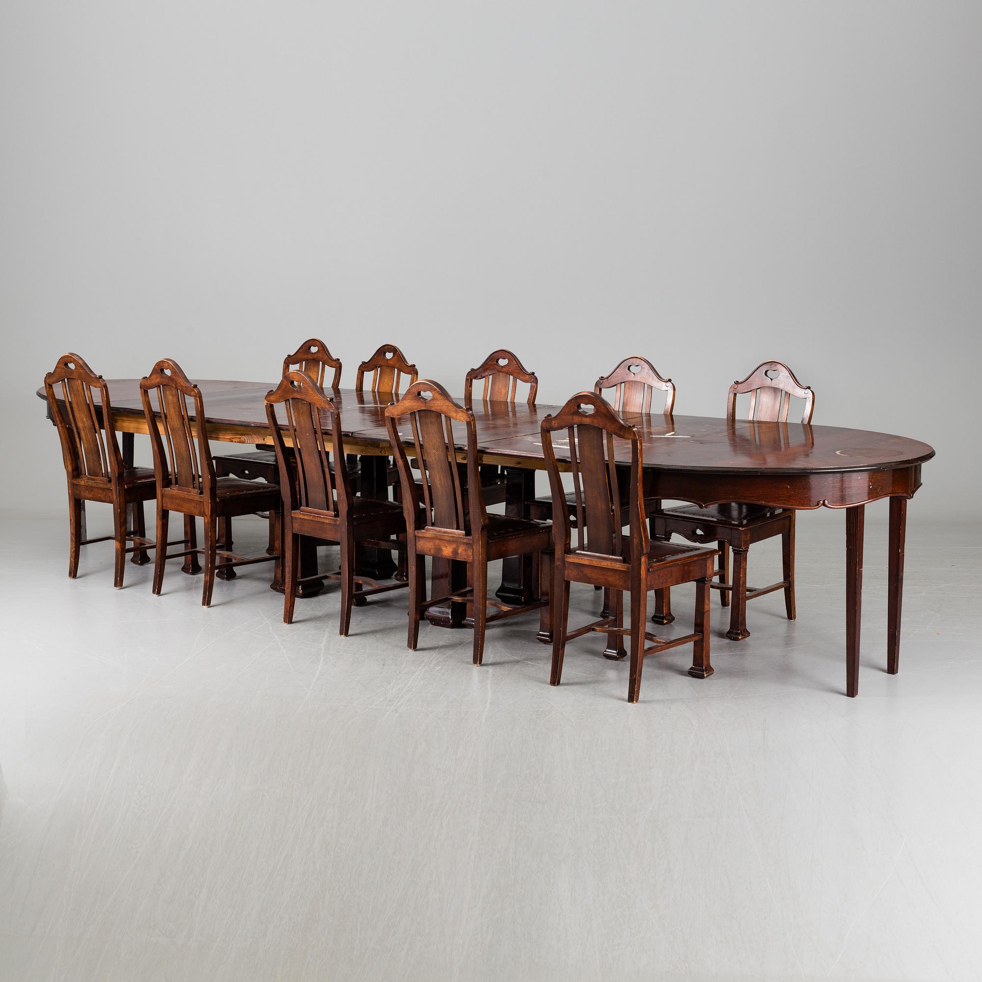 A late 19th century dining table with ten chairs and five extension leaves.