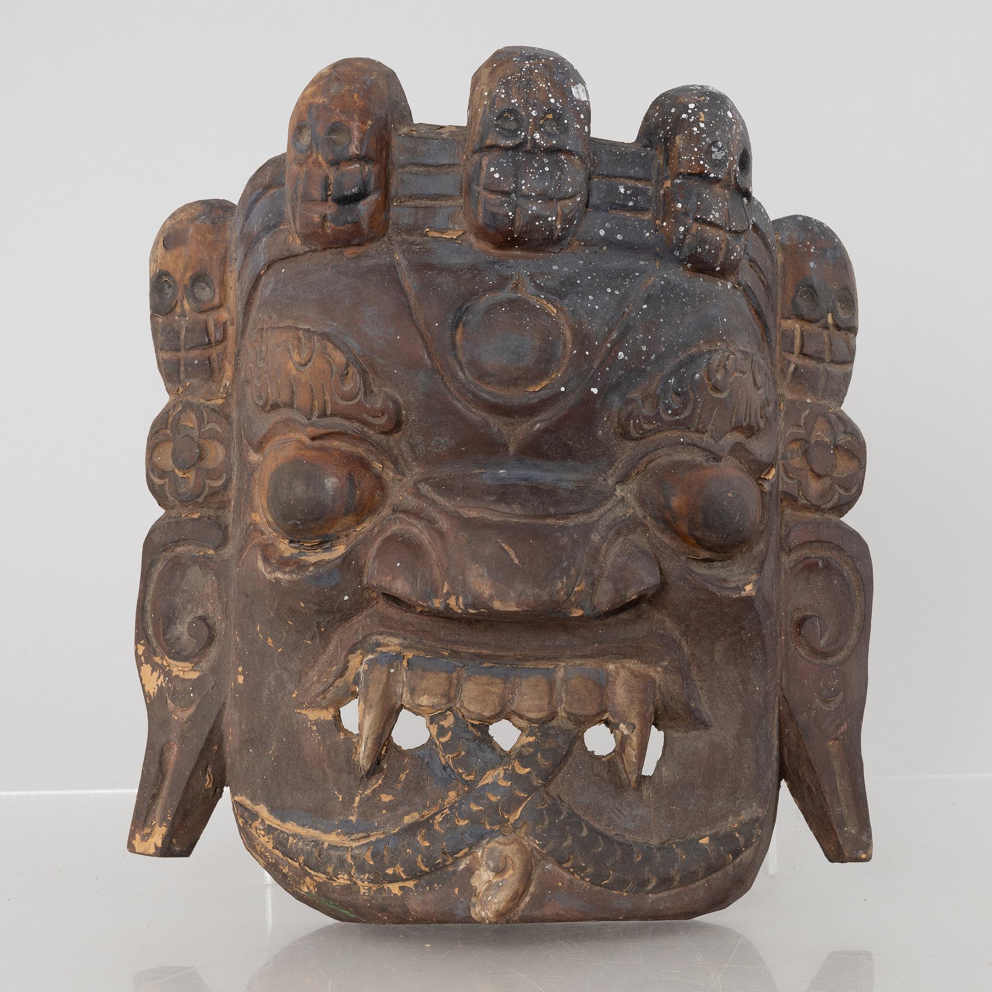 Four Tibetan/South East Asian wooden decorations, 20th century.