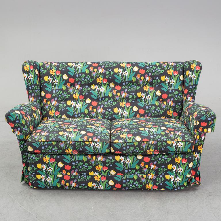A sofa and wingback chair, later part of the 20th Century.