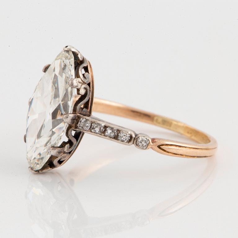 A 14K gold and silver ring set with a navette-cut diamond with a total weight of ca 2.75 cts quality ca K vs.