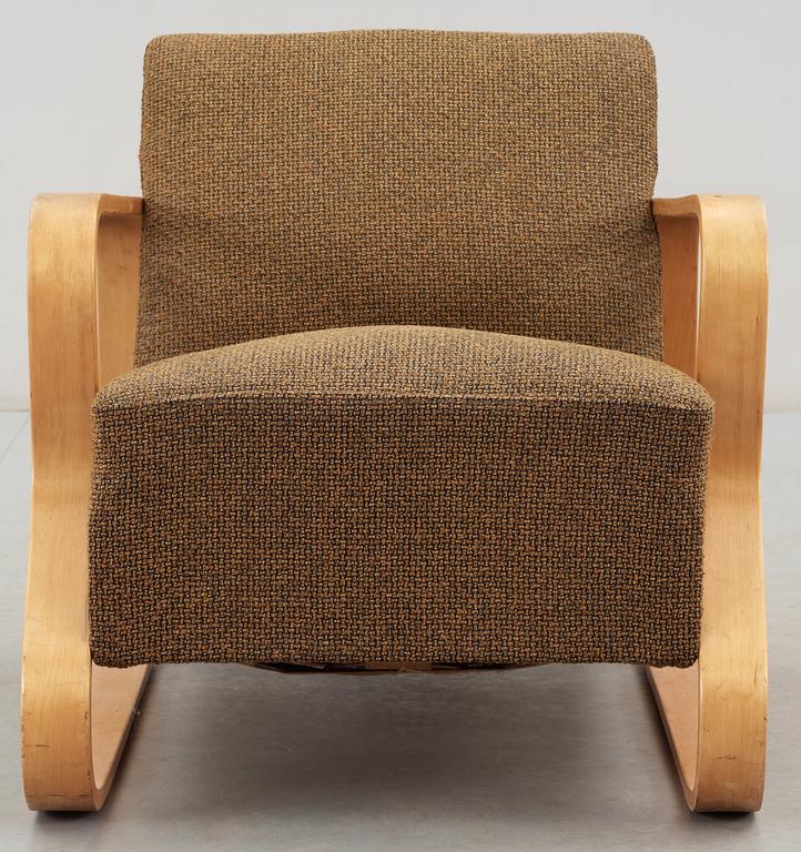 An Alvar Aalto laminated birch 'padded Paimio chair', upholstered in yellow and black fabric.