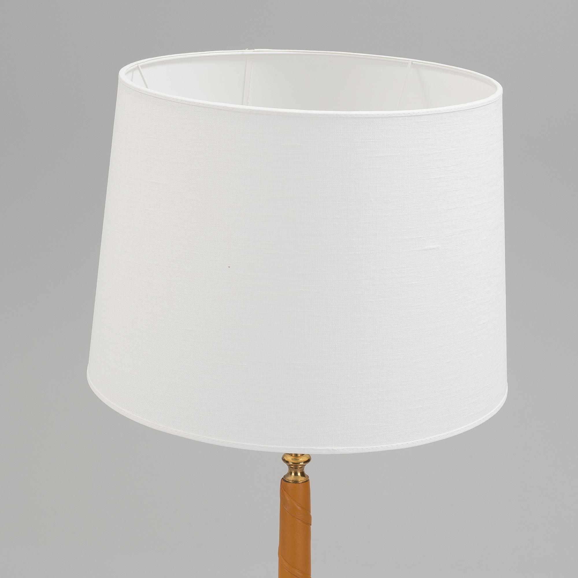 A 1960s brass and leather floor light.
