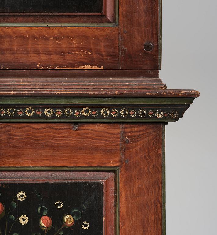 A Swedish polychrome painted folk art corner cabinet, dated 1818.