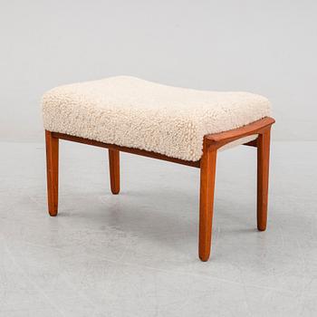 A Danish mid 20th Century sheepskin upholstered ottoman.