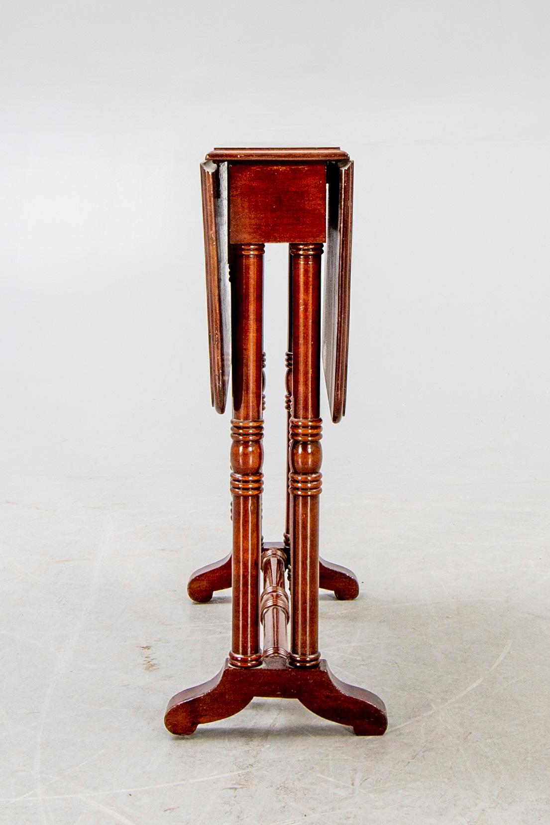 A 20th century English mahogany folding table.