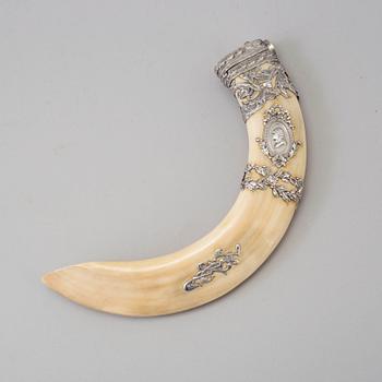 An early 20th century cigar cutter made of a wildboars tusk with silvermountings.