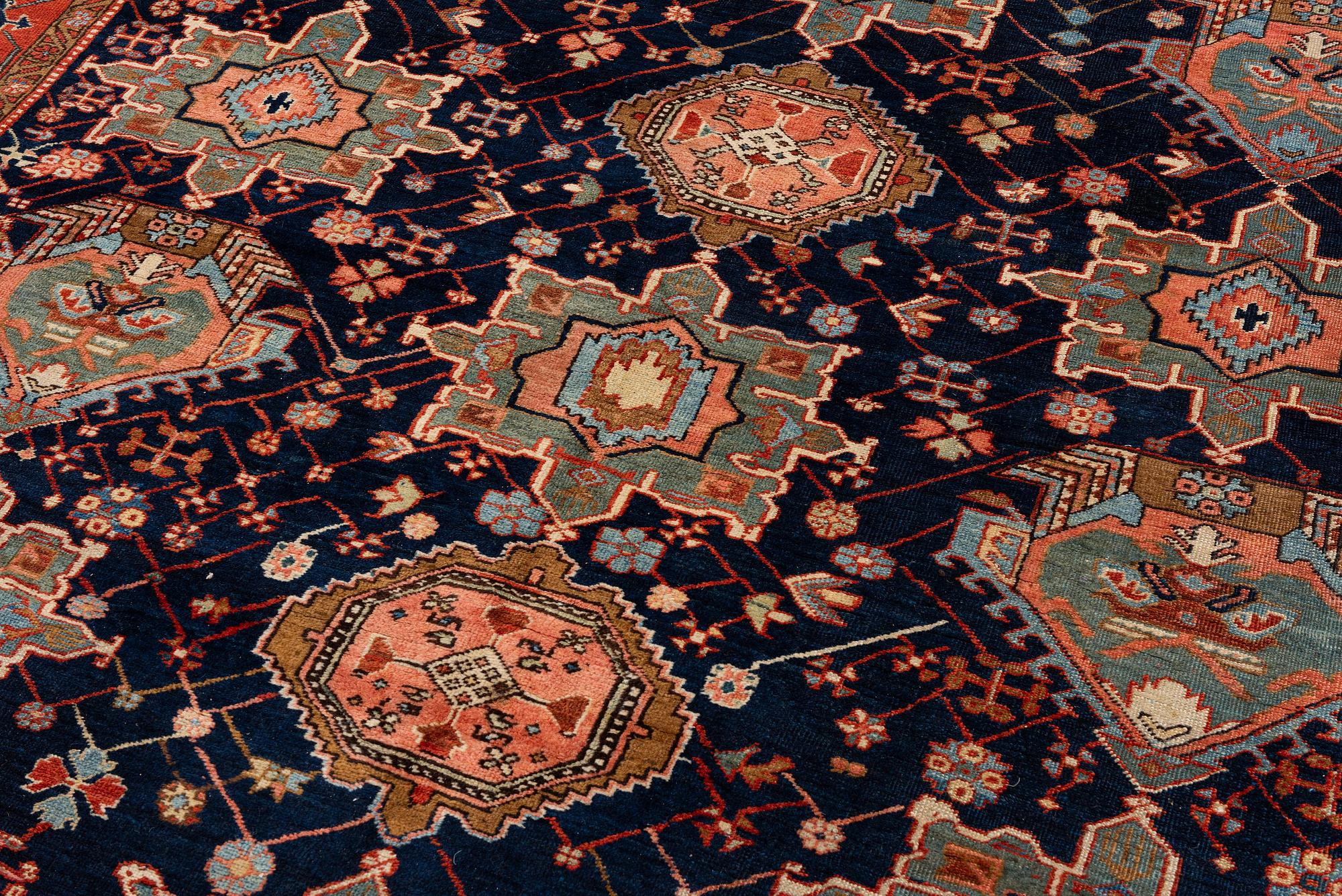 An antique Heriz carpet of karadja design, Northwest Persia (Iran), c. 338 x 239 cm.