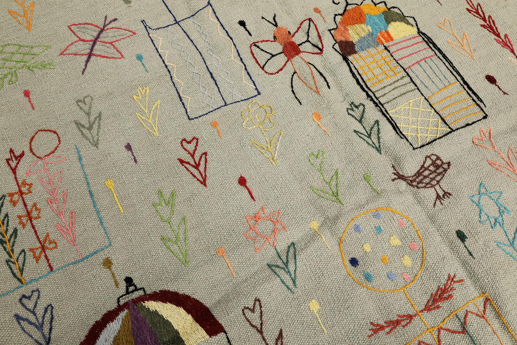 A hand-embroidered Kilim rug, approx. 241 x 183 cm.