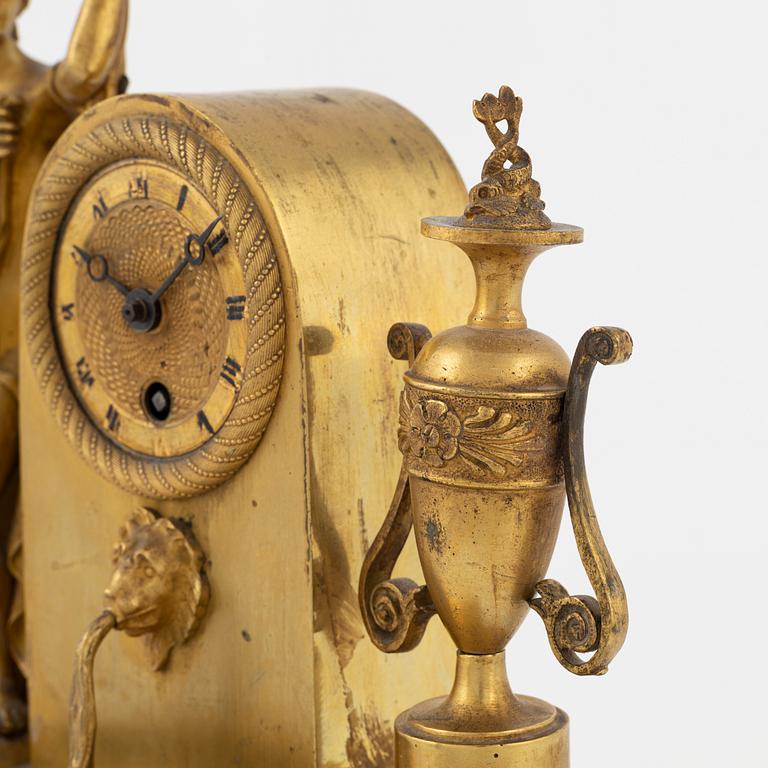 An ormolu Empire mantel clock, first part of the 19th century.
