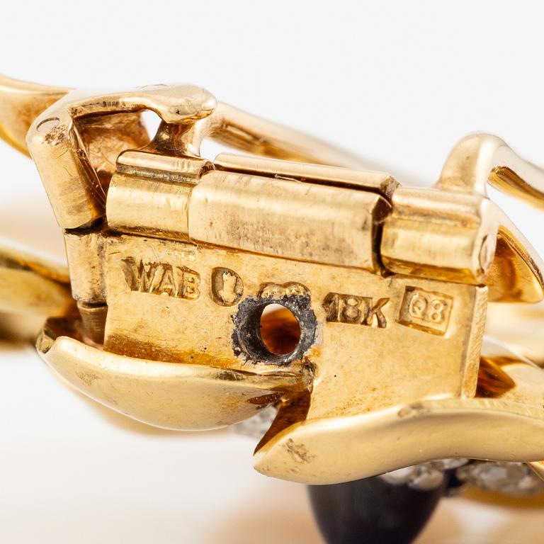 A W.A. Bolin brooch 18K gold with a cabochon-cut sapphire and rose-cut diamonds, Stockholm 1942.