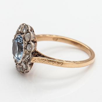 A 13-14K gold ring with a synthetic spinelle and rose-cut dimaonds.