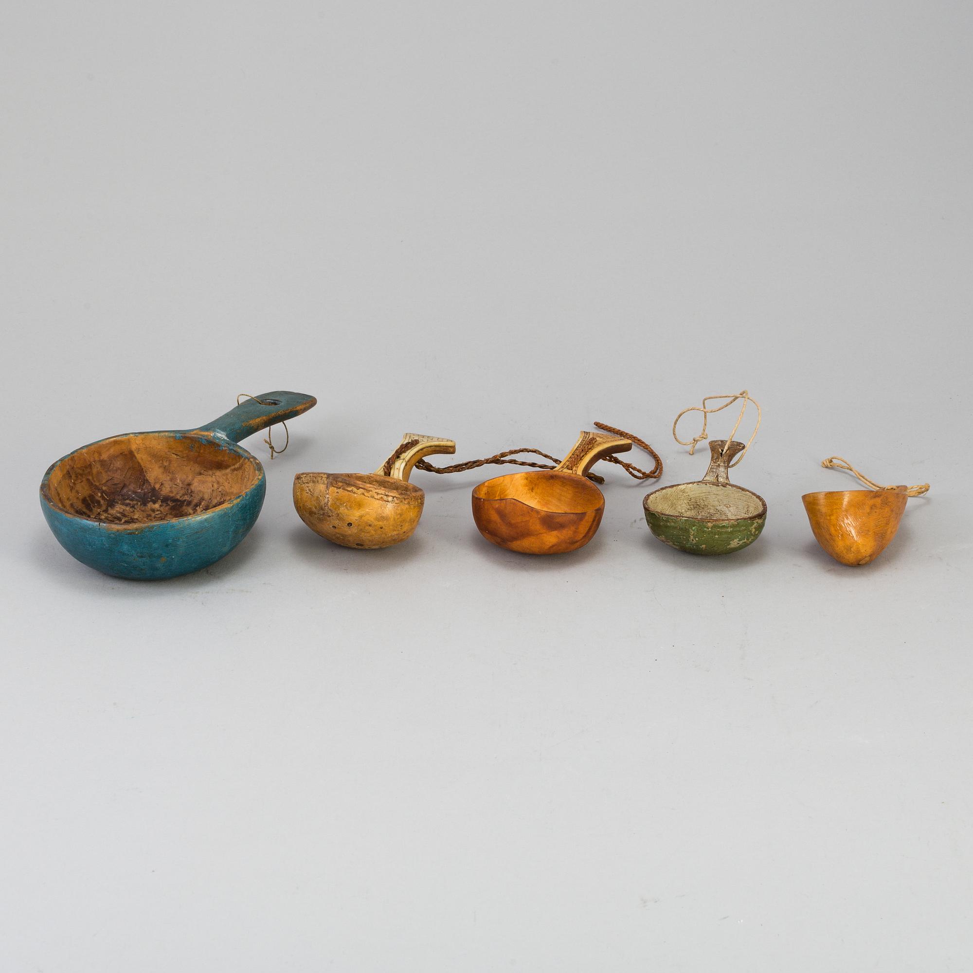 A set of five amongst others Sami cups made of birchwood and reindeer antlers.