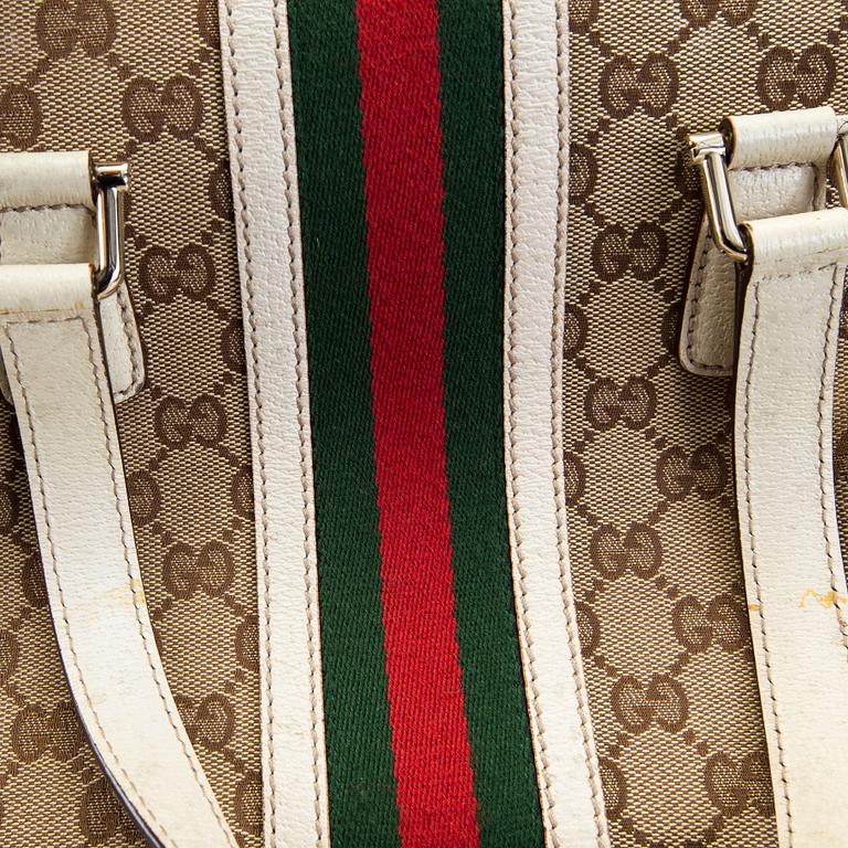 A Gucci canvas and leather hand bag.