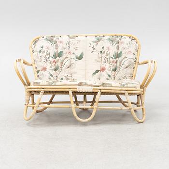 A rattan sofa, table and a pair of armchairs, second part of the 20th Century.