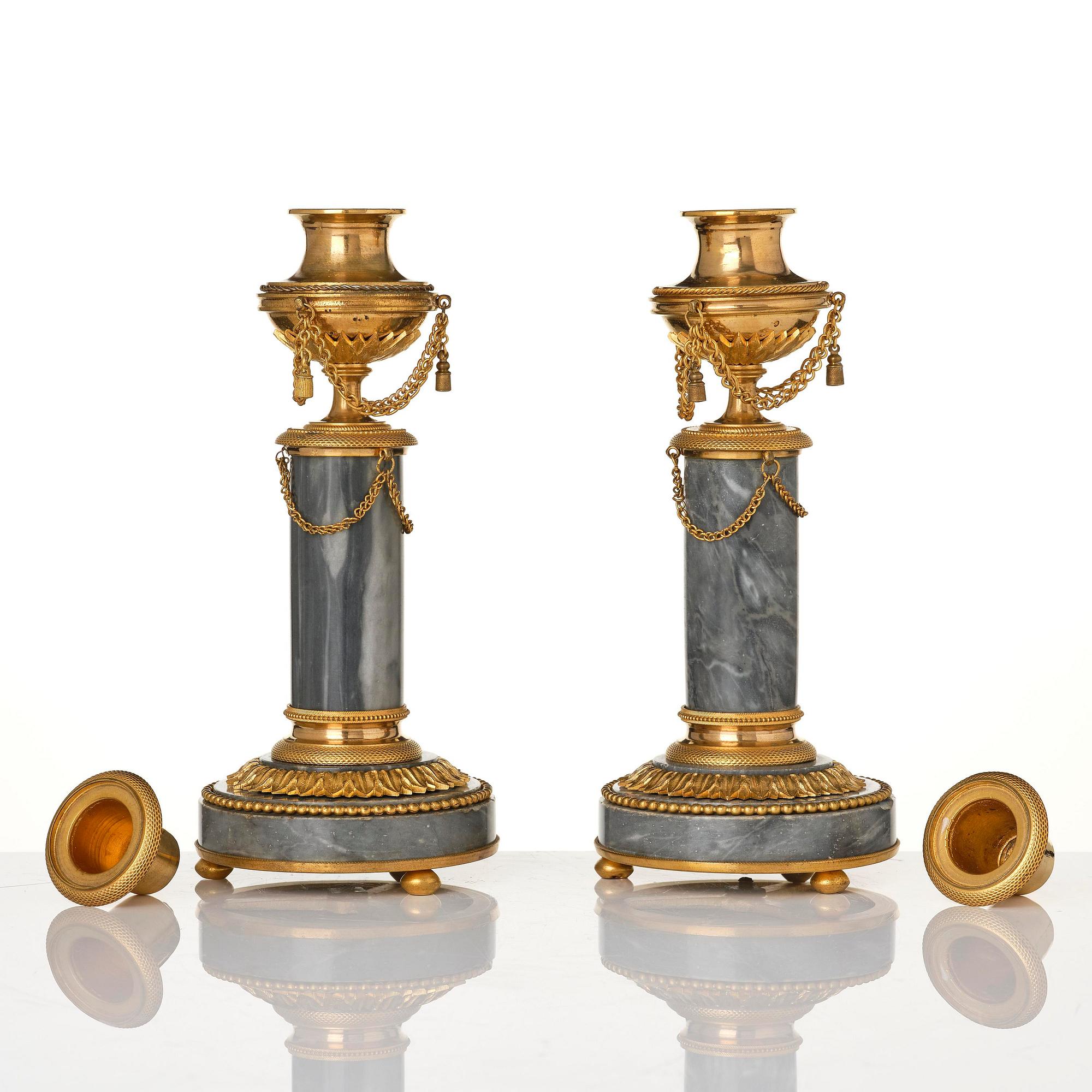 A pair of Louis XVI ormolu and Bleu turquin candlesticks.