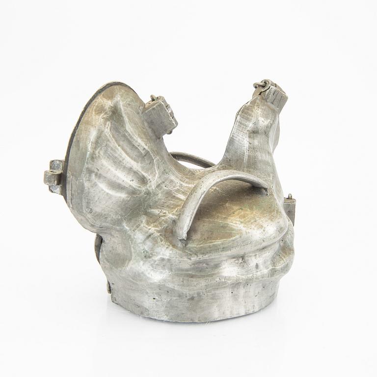 A set of four pewter icecream moulds around 1900.