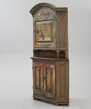 A Swedish polychrome-painted corner cabinet attributed to J. Bäckström (1773-1837).