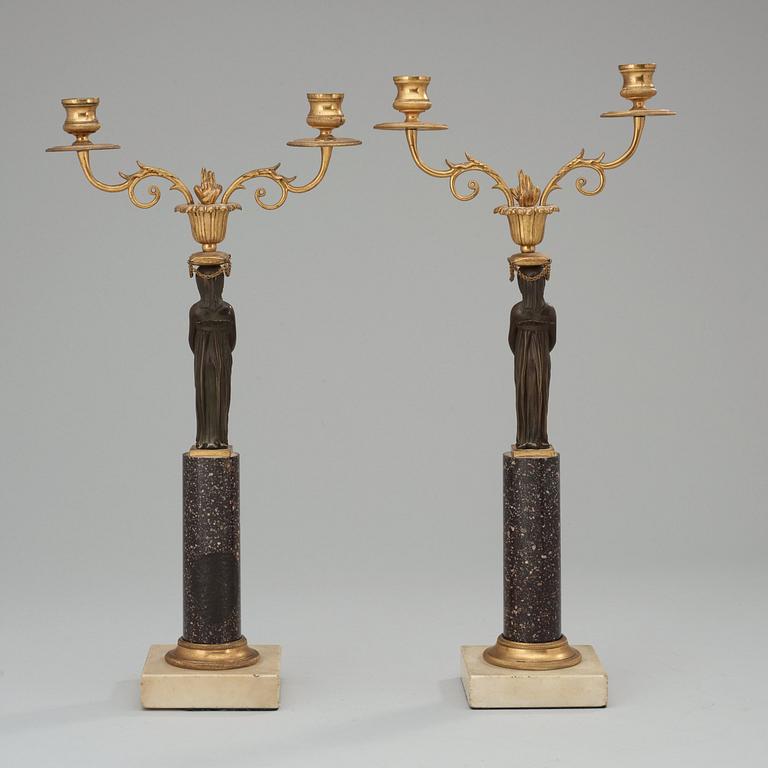 A pair of late Gustavian porphyry and bronze two-light candelabra.