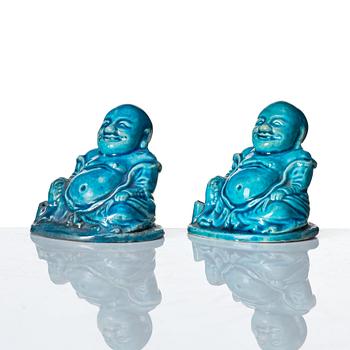 A pair of turquoise glazed joss stick holders in the shape of Buddai, Qing dynasty, 18th Century.