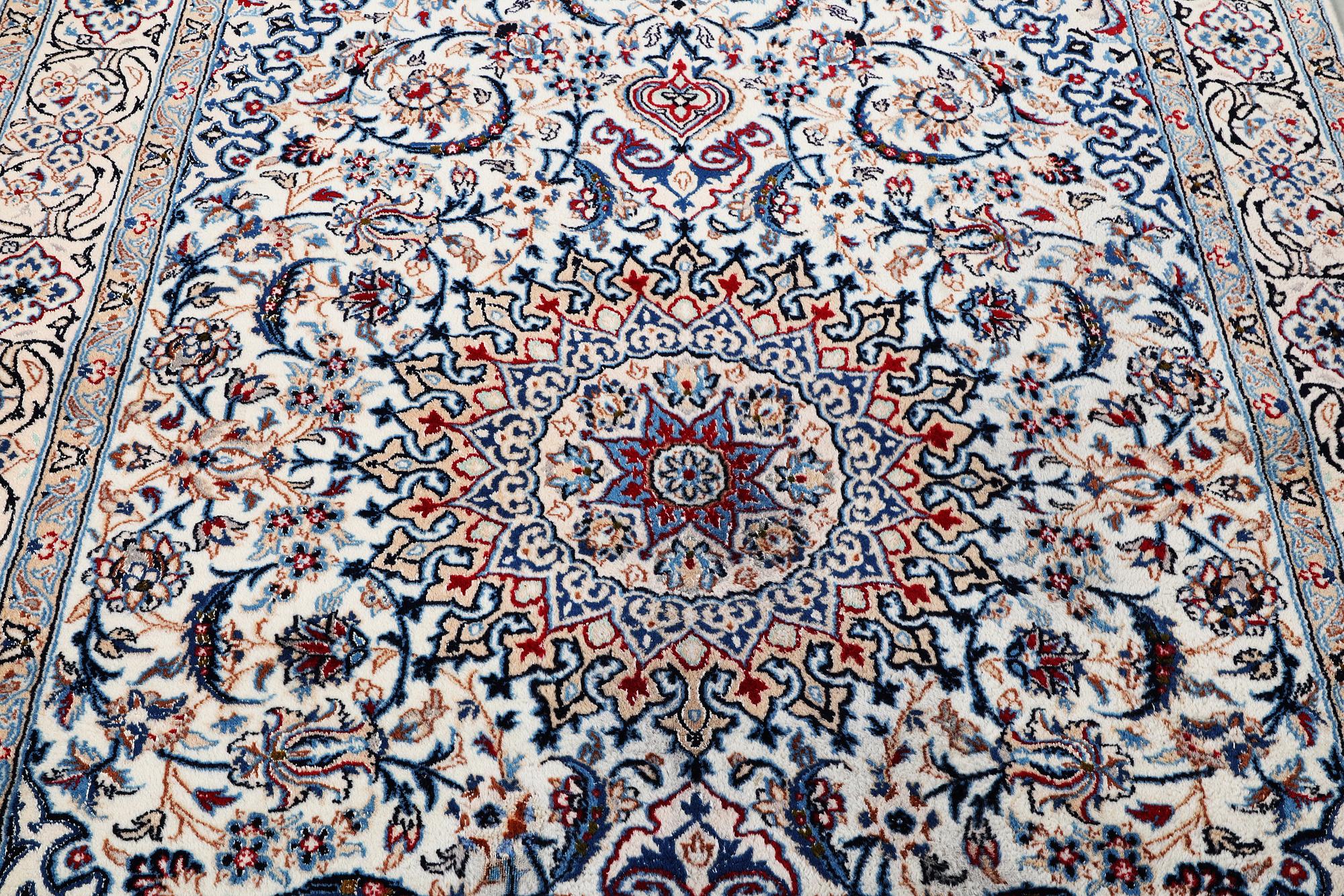 A Nain carpet, part silk, c. 293 x 199 cm.