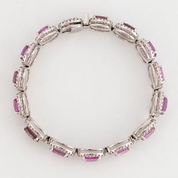 An 18K white gold bracelet set with faceted pink sapphires and round brilliant-cut diamonds.