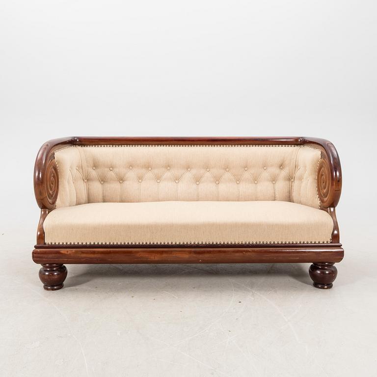 An early 1900s Art deco walnut sofa.