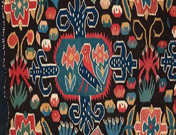 A CARRIAGE CUSHION FRAGMENT, tapestry weave, "Den innelykta fågeln", ca 52 x 67 cm, Scania (Sweden).