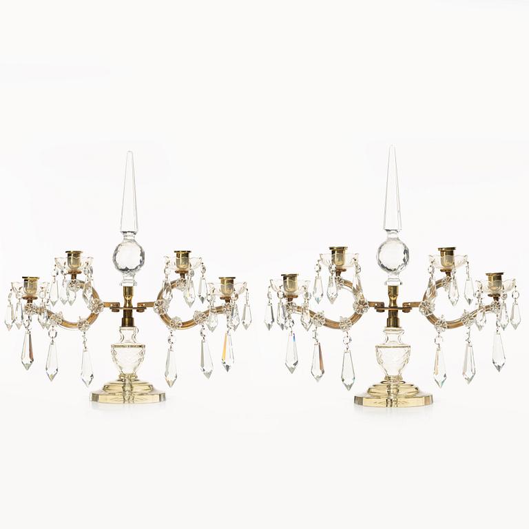 A pair of brass and glass canelabras, first half of the 20th century.