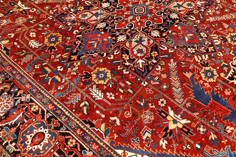 A  semi-antique Heris carpet, approx. 396 x 286 cm.