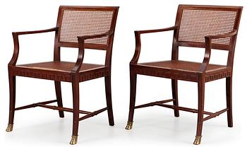 A pair of mahogany and ratten armchairs, Nordiska Kompaniet, Stockholm 1920's-30's.