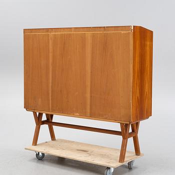 A teak-veneered mid 20th century sideboard.