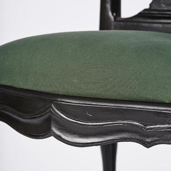 A set of eight black Swedish rococo chairs.