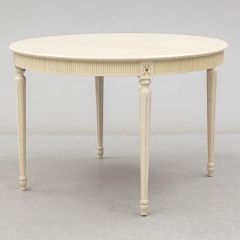 A set of eight chairs and a dining table. Gustavian style, second half of the 20th century. 2 leaves included.