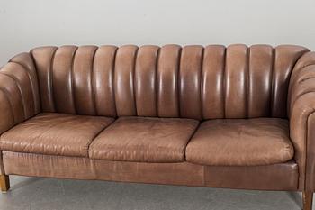 A leather sofa and armchair, 20th century latter part.