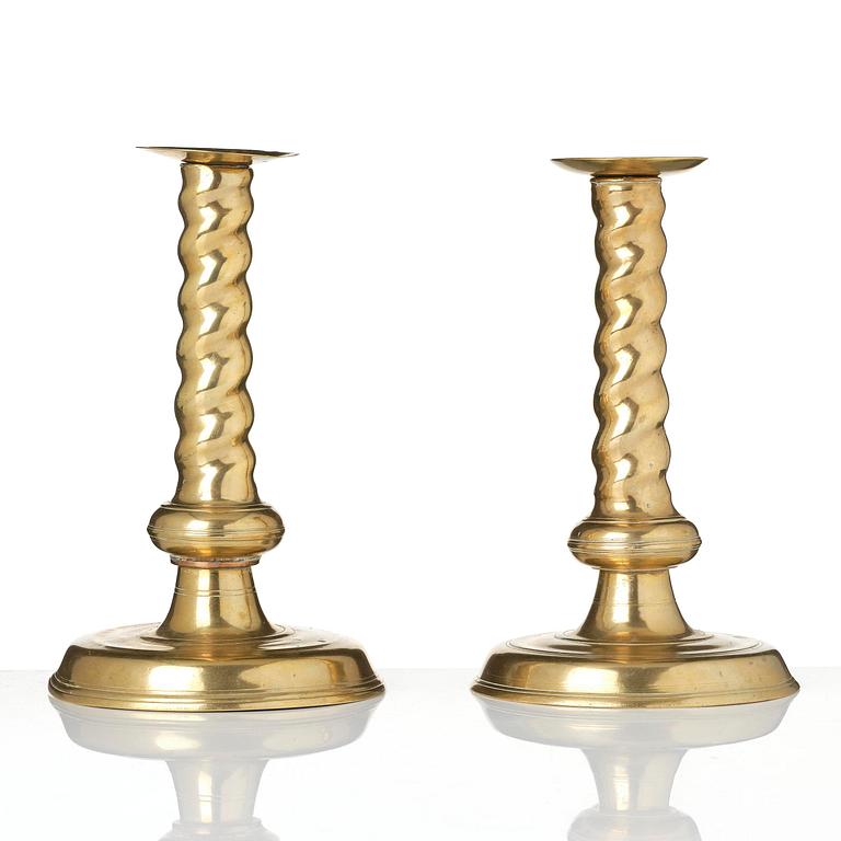 A pair of Northern European cast brass baroque candlesticks, circa 1700.