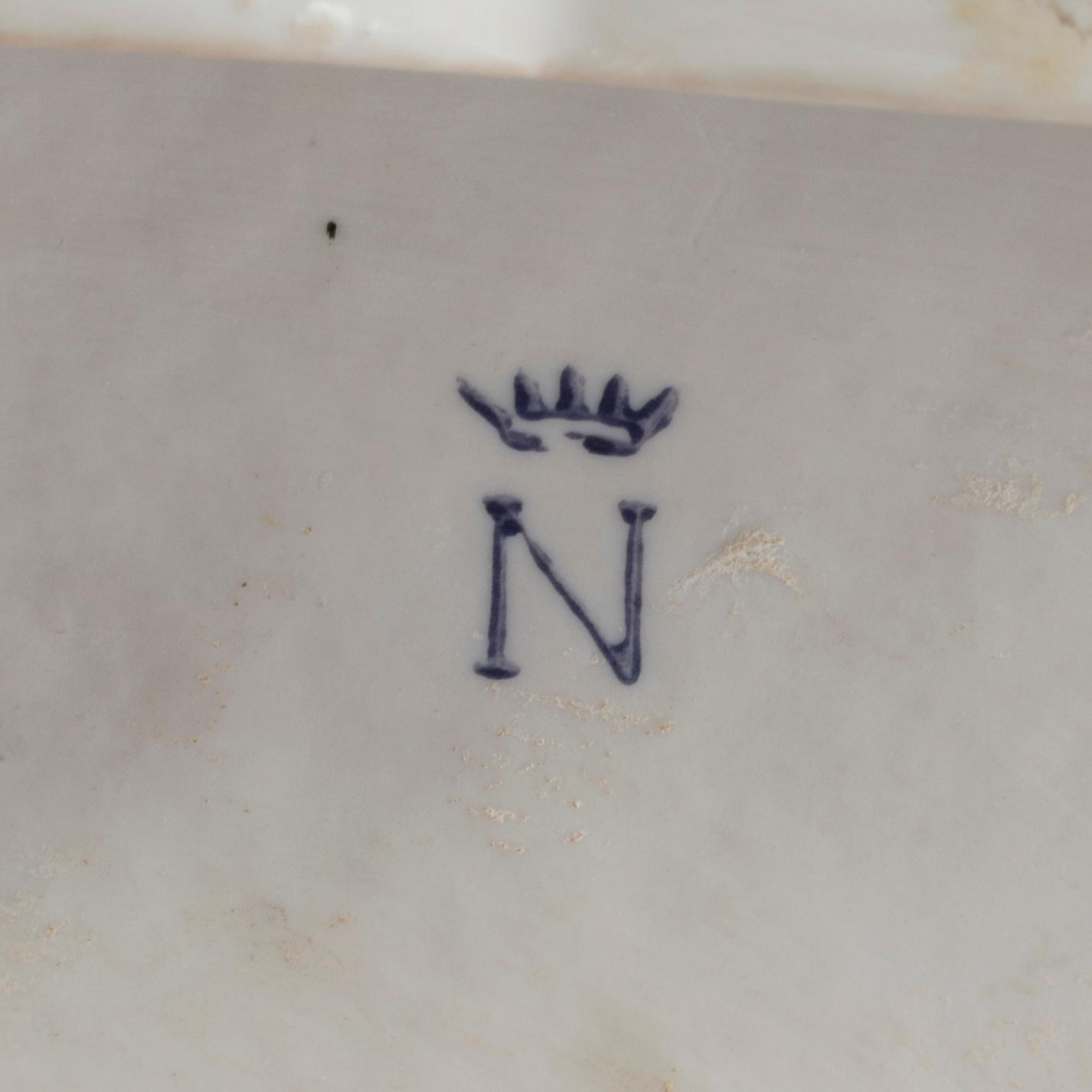 A porcelain figurine with Capodimonte looking mark.