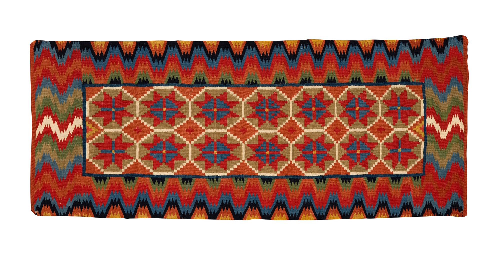 A carriage cushion, double-interlocked tapestry, ca 109,5 x 46 cm, Scania, Sweden.